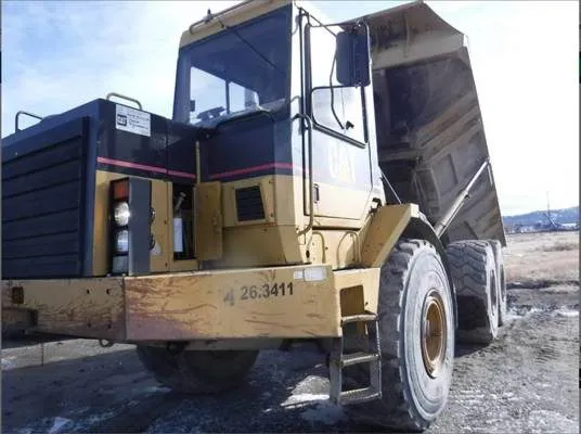 A caterpillar rock truck dumping a load of rocks.
